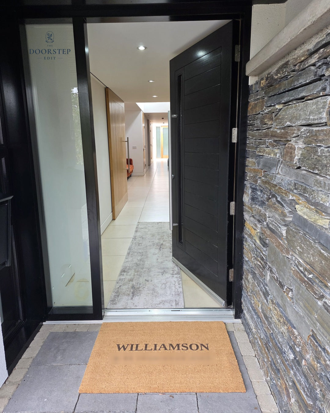 Customer photo: The House Name doormat in Extra large on a real customer's covered doorstep (address blurred for privacy)